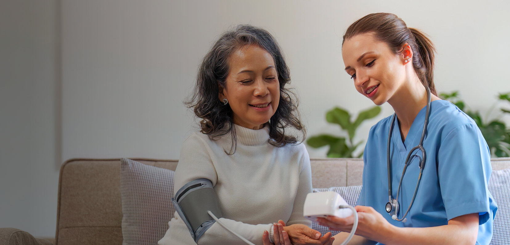 A nurse monitoring the health of an elderly woman