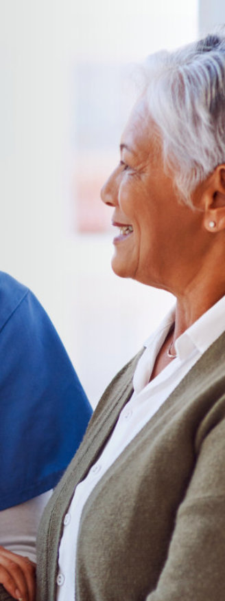 A nurse smilingly looking at the elderly