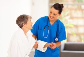 A nurse assisting an elderly woman