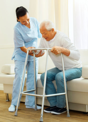 A nurse assisting the elderly man to stand up