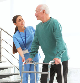 A nurse smiling at an elderly man