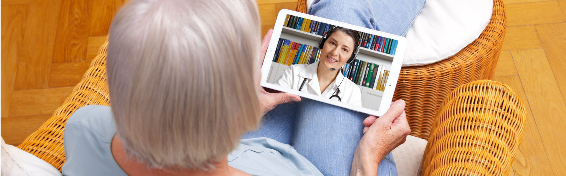 An elderly woman watching at the tablet