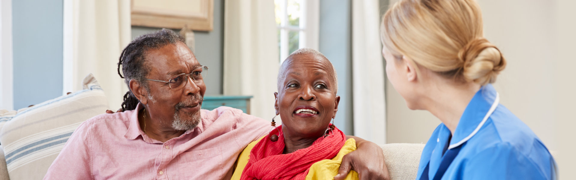 A nurse talking to the elderly couple